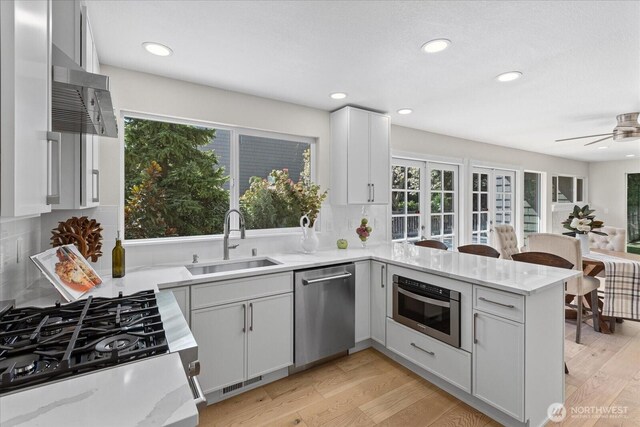 1825 112th Ave NE, Bellevue, WA 98004 - kitchen featuring a sink, appliances with stainless steel finishes, plenty of natural light, and a peninsula