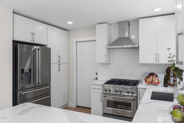 1825 112th Ave NE, Bellevue, WA 98004 - kitchen featuring light stone counters, wall chimney range hood, white cabinets, and stainless steel appliances