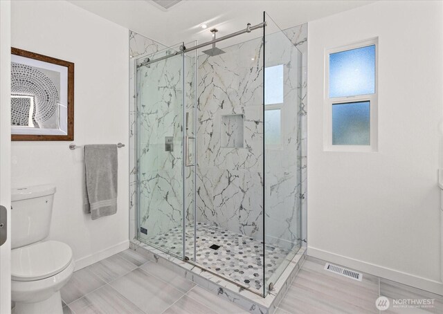 1825 112th Ave NE, Bellevue, WA 98004 - full bath with toilet, visible vents, baseboards, and a marble finish shower