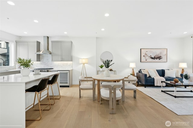 dining space with recessed lighting and light wood finished floors