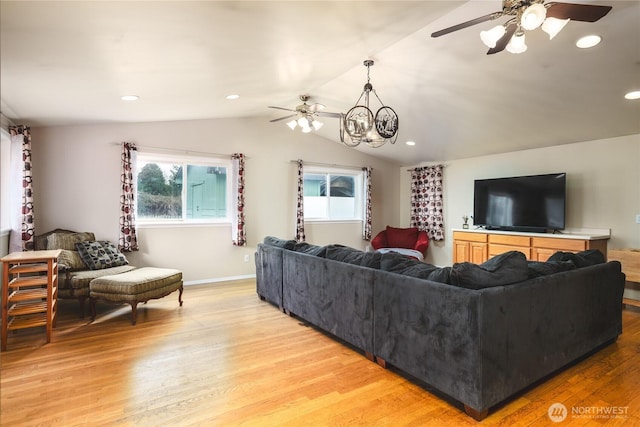 living area with light wood-type flooring, a ceiling fan, and lofted ceiling