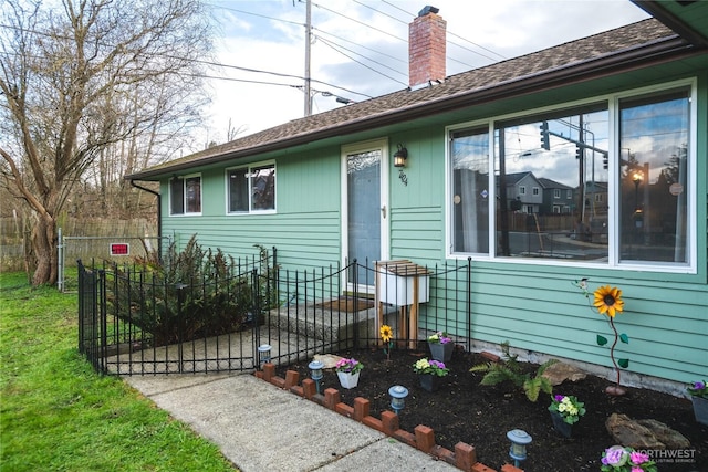 view of front of property with fence, a gate, and a chimney