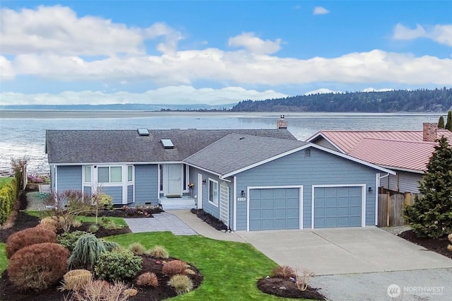 858 Livingston Bay Shore Dr, Camano Island, WA 98282 - ranch-style home with a water view, a garage, concrete driveway, and fence