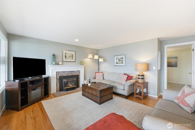 858 Livingston Bay Shore Dr, Camano Island, WA 98282 - living room featuring baseboards, wood finished floors, recessed lighting, and a brick fireplace
