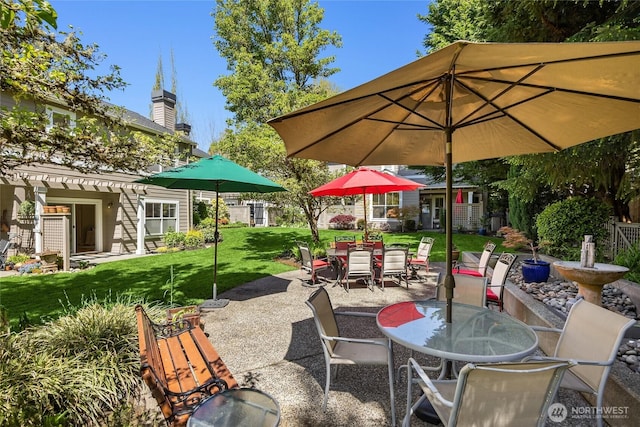 view of patio featuring outdoor dining space and an outdoor structure