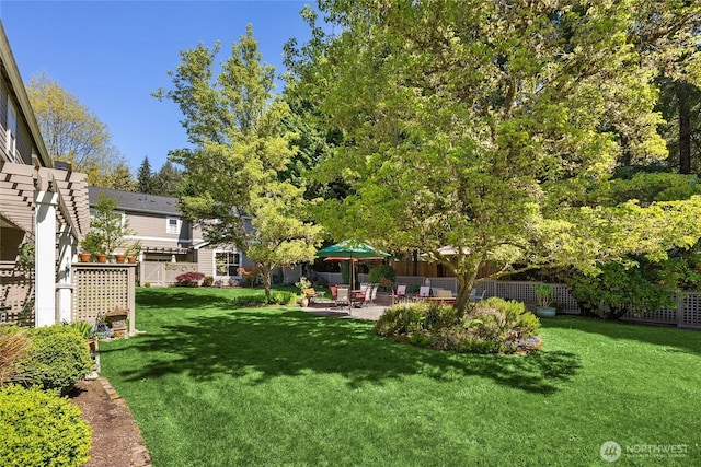 view of yard featuring fence and a patio area