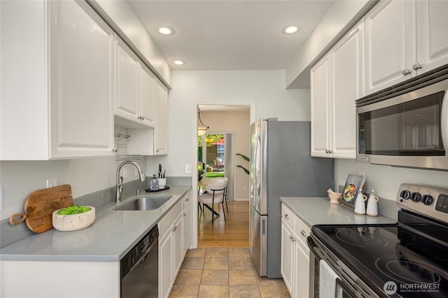 kitchen with white cabinetry, appliances with stainless steel finishes, a sink, and recessed lighting