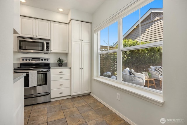 kitchen with light countertops, baseboards, stainless steel appliances, recessed lighting, and white cabinetry