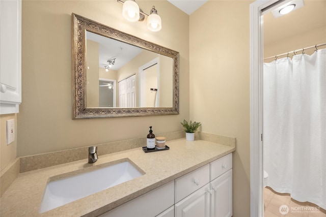 full bathroom featuring vanity, curtained shower, and toilet