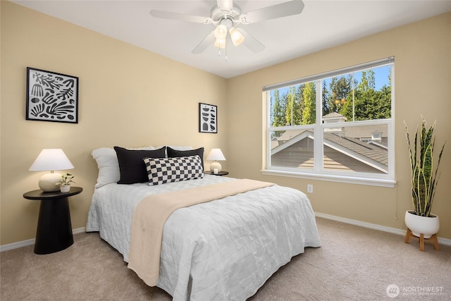 carpeted bedroom with baseboards and a ceiling fan