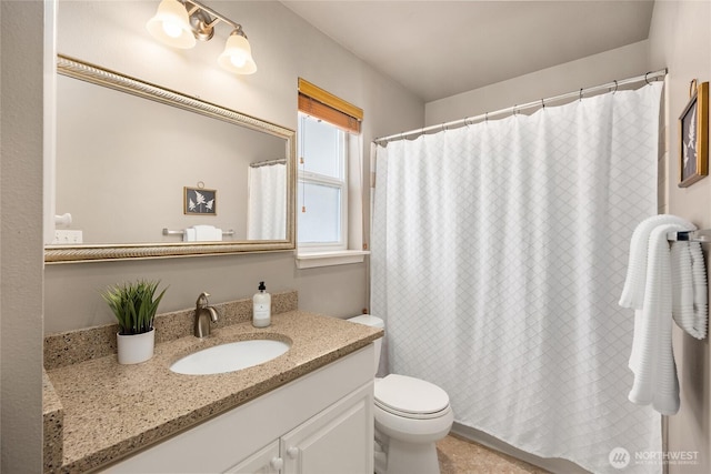 bathroom with vanity, toilet, and curtained shower