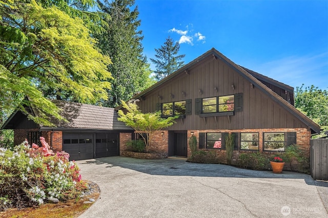 16521 NE 1st Pl, Bellevue, WA 98008 - view of front of property with brick siding, driveway, a garage, and board and batten siding