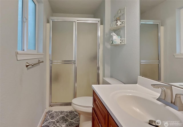 604 27th Ave SE, Puyallup, WA 98374 - bathroom featuring toilet, a shower stall, and vanity