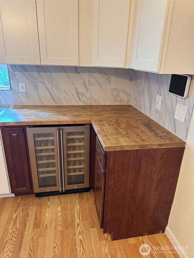 604 27th Ave SE, Puyallup, WA 98374 - bar featuring wine cooler, decorative backsplash, a dry bar, and light wood-style floors