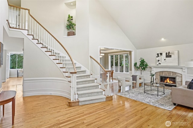 2070 277th Ave SE, Sammamish, WA 98075 - living room with high vaulted ceiling, wood finished floors, stairs, and a tile fireplace