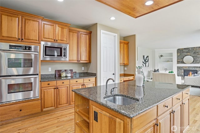 2070 277th Ave SE, Sammamish, WA 98075 - kitchen with stainless steel appliances, a sink, light wood-type flooring, open floor plan, and recessed lighting