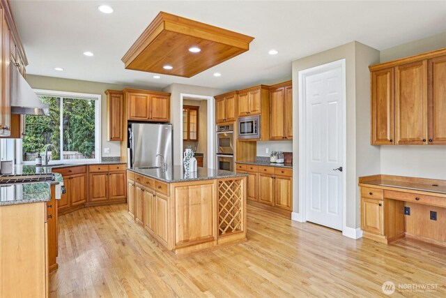 2070 277th Ave SE, Sammamish, WA 98075 - kitchen with stainless steel appliances, a sink, light wood-style floors, extractor fan, and recessed lighting