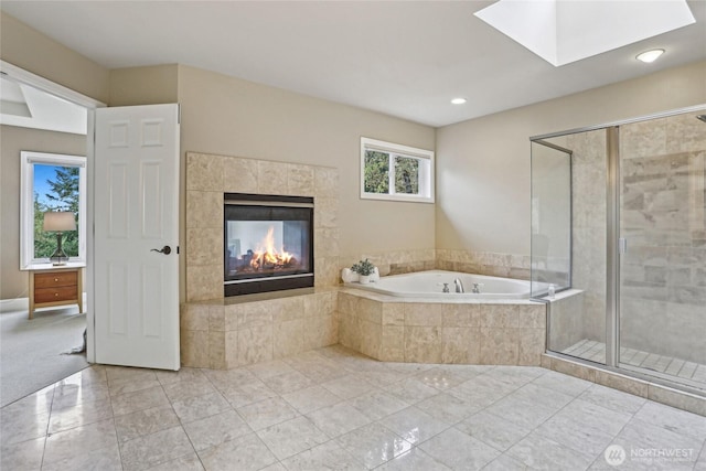 2070 277th Ave SE, Sammamish, WA 98075 - full bath with a garden tub, a shower stall, a fireplace, a skylight, and tile patterned floors