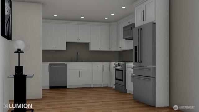 417 N Columbia St, Chelan, WA 98816 - kitchen featuring appliances with stainless steel finishes, a sink, light wood-style flooring, decorative backsplash, and recessed lighting