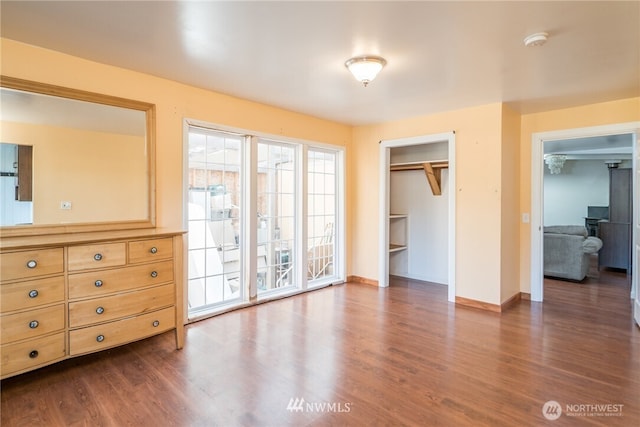 11709 26th Ave NE, Seattle, WA 98125 - unfurnished bedroom with a closet, baseboards, dark wood finished floors, and access to outside