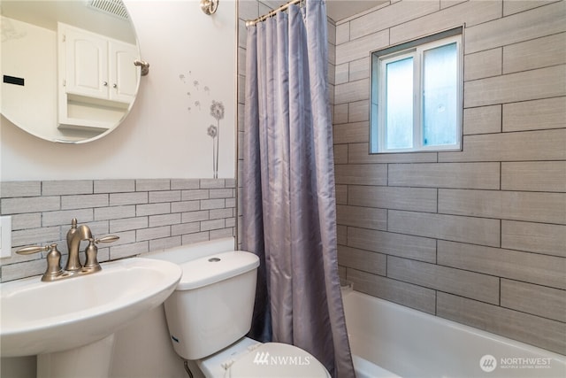 11709 26th Ave NE, Seattle, WA 98125 - full bath with visible vents, toilet, shower / tub combo, tile walls, and a sink