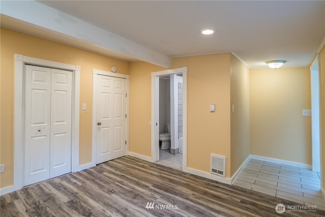 11709 26th Ave NE, Seattle, WA 98125 - unfurnished bedroom with visible vents, wood finished floors, recessed lighting, a closet, and baseboards