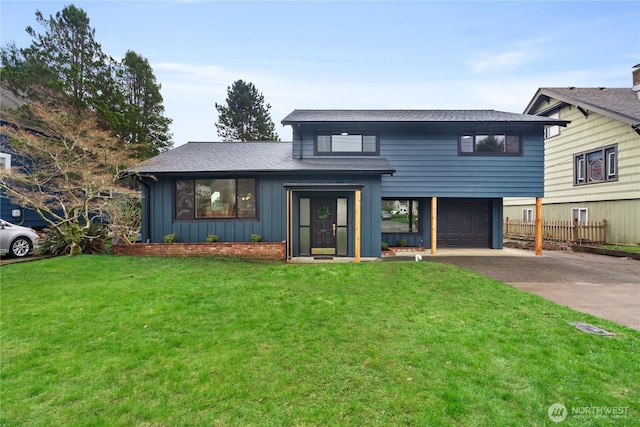 1309 W 5th St, Aberdeen, WA 98520 - view of front of home with board and batten siding, a front yard, driveway, and a garage