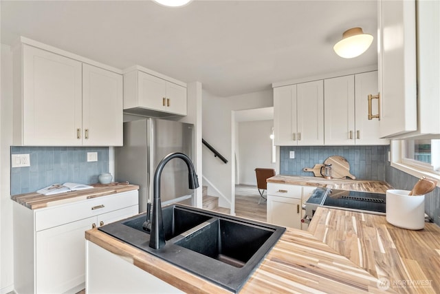 1309 W 5th St, Aberdeen, WA 98520 - kitchen with white cabinetry, backsplash, a sink, wood counters, and appliances with stainless steel finishes