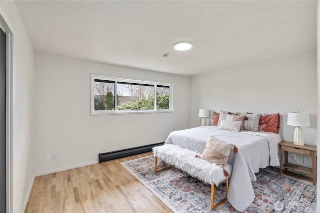1309 W 5th St, Aberdeen, WA 98520 - bedroom featuring baseboards, wood finished floors, and a baseboard radiator