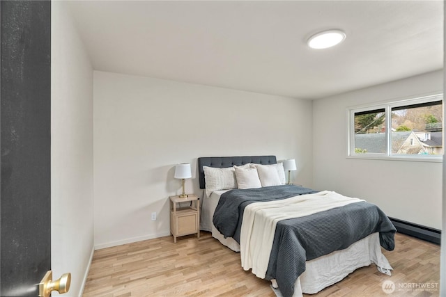 1309 W 5th St, Aberdeen, WA 98520 - bedroom featuring baseboards, light wood finished floors, and a baseboard radiator