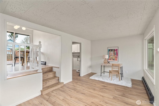 1309 W 5th St, Aberdeen, WA 98520 - interior space featuring a baseboard radiator, wood finished floors, baseboards, and stairs