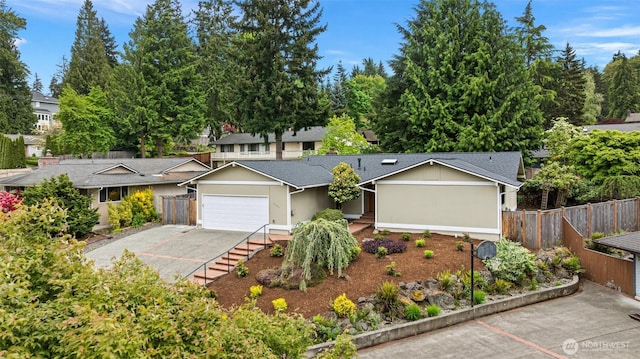traditional-style home featuring fence and a garage