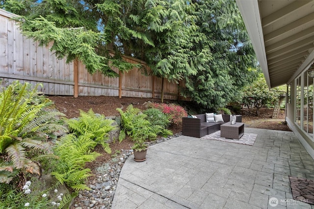 view of patio / terrace with an outdoor living space and a fenced backyard