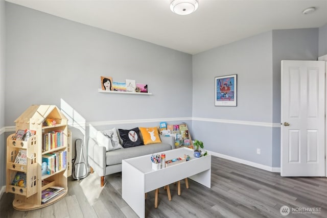 playroom featuring wood finished floors and baseboards