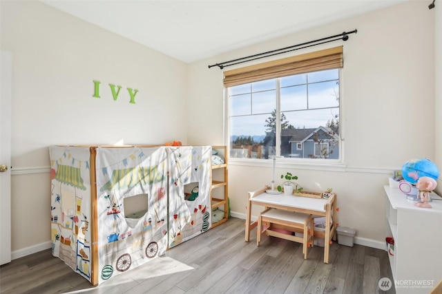 bedroom with baseboards and wood finished floors