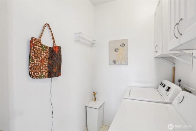 clothes washing area featuring cabinet space and separate washer and dryer