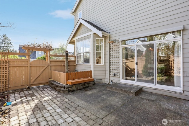 view of patio / terrace with fence and a gate