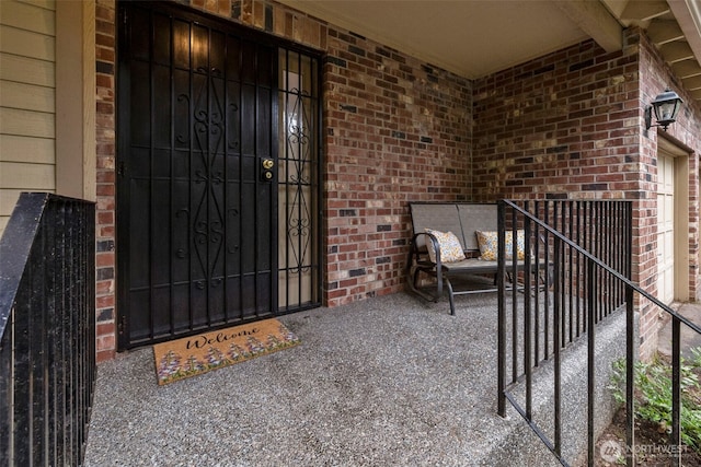 doorway to property with brick siding