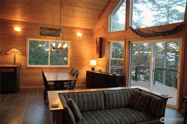863 Chinook Way, Anacortes, WA 98221 - living room featuring vaulted ceiling, a notable chandelier, wood ceiling, and wood walls