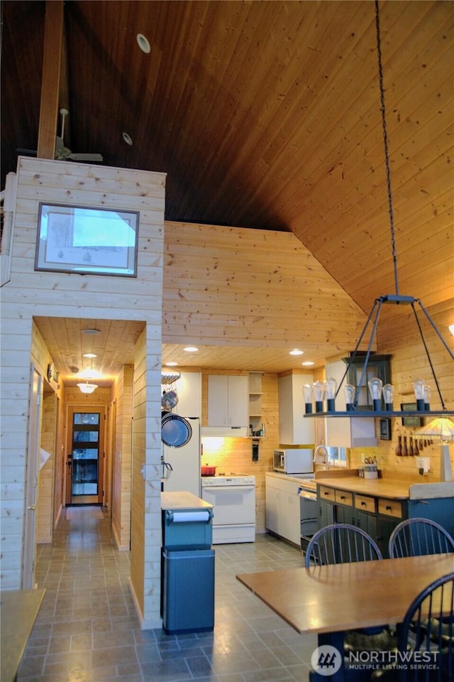 863 Chinook Way, Anacortes, WA 98221 - kitchen with open shelves, white appliances, wooden walls, and wood ceiling
