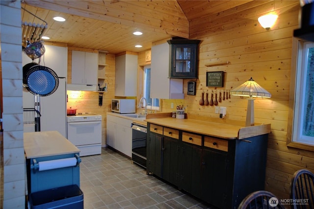 863 Chinook Way, Anacortes, WA 98221 - kitchen featuring wooden walls, a sink, light countertops, white appliances, and open shelves