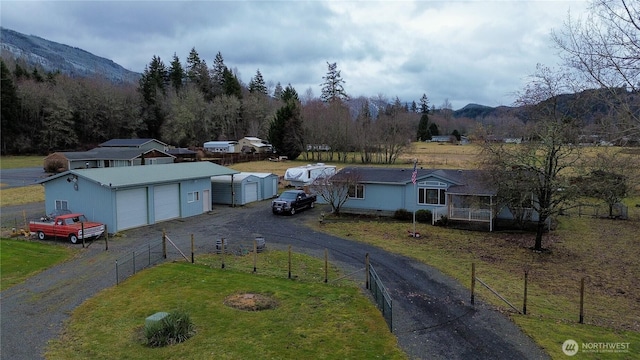 136 Mule Dr, Glenoma, WA 98336 - view of front facade with an outbuilding, driveway, fence, a front yard, and a garage