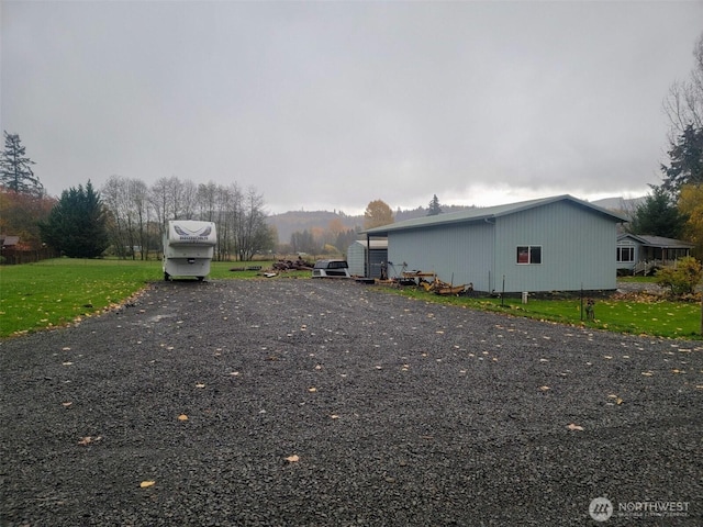 136 Mule Dr, Glenoma, WA 98336 - view of side of property with a yard, an outdoor structure, and a pole building