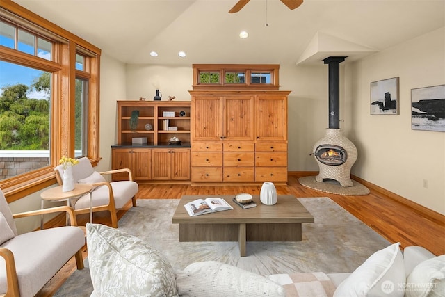 living area featuring light wood-style floors, a ceiling fan, recessed lighting, lofted ceiling, and baseboards