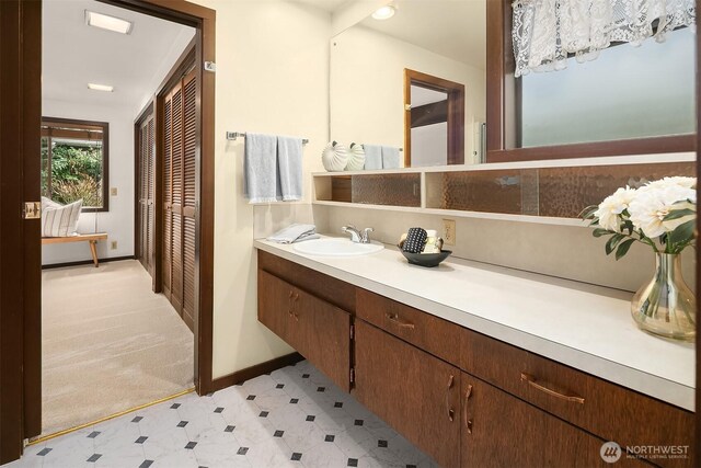 bathroom with tile patterned floors, vanity, and baseboards