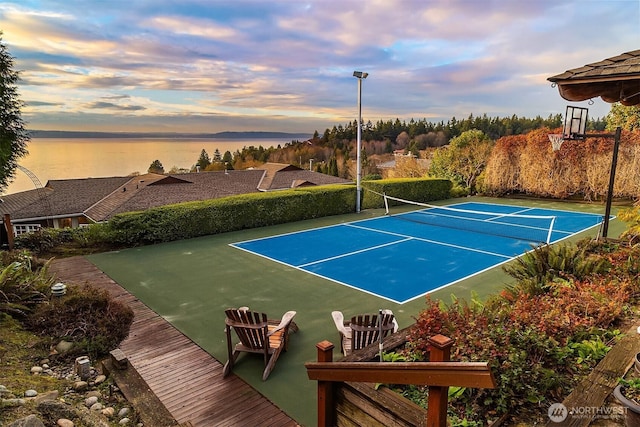 view of sport court featuring a water view