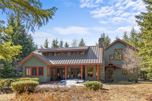 121 Hard Scrabble Ln, Cle Elum, WA 98922 - rear view of house with a chimney, a standing seam roof, board and batten siding, and metal roof