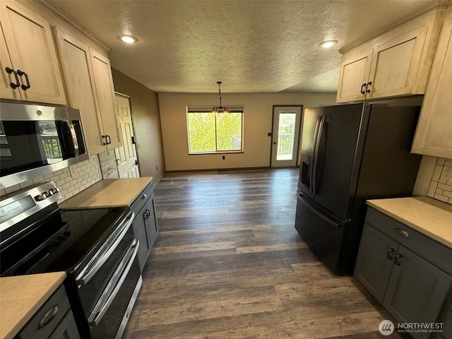 kitchen with decorative backsplash, a textured ceiling, appliances with stainless steel finishes, and dark wood-style floors