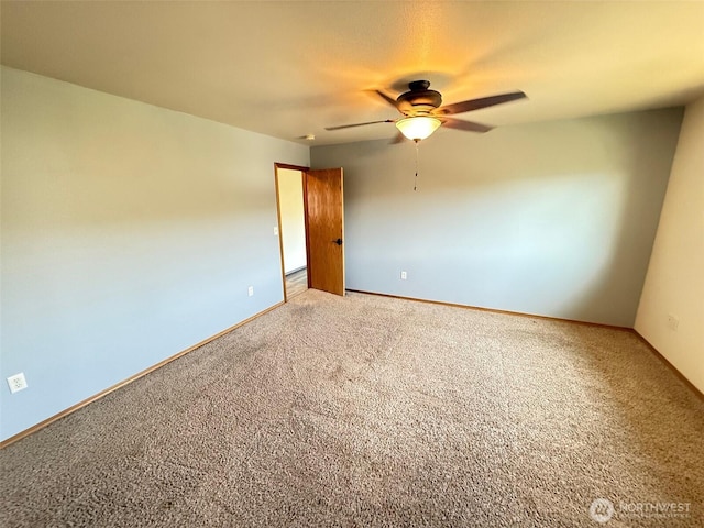 empty room featuring baseboards, ceiling fan, and light colored carpet