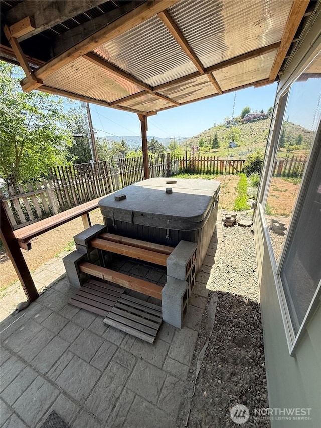 view of patio with a fenced backyard and a hot tub